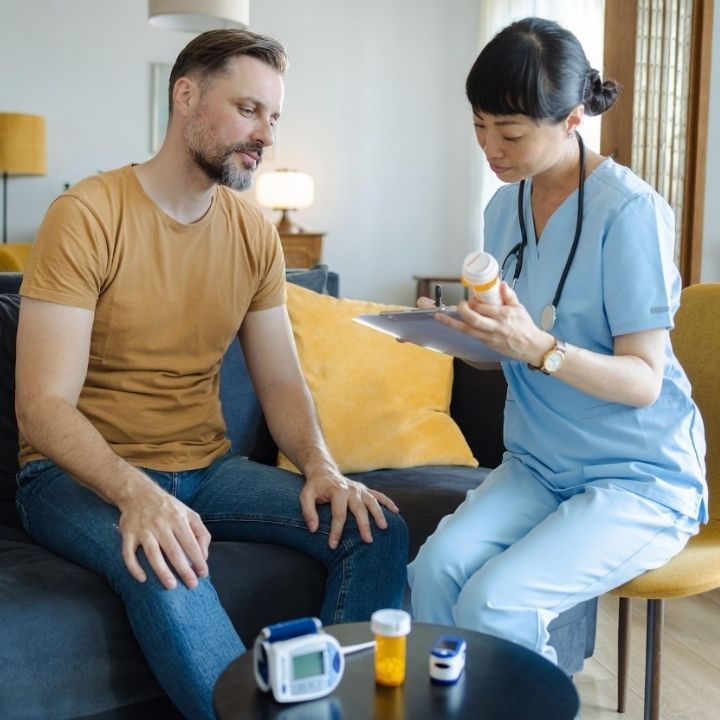 A psychiatric nurse practitioner reviewing prescription and health readings with patient.